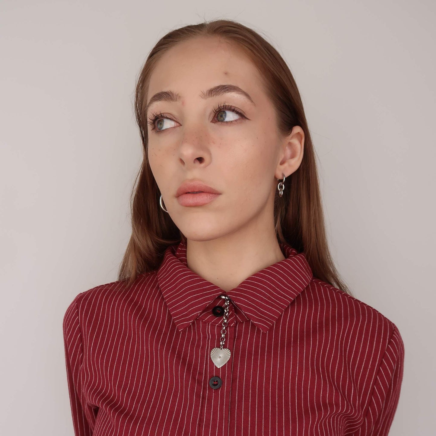 Woman wearing a red striped shirt with a neutral background
