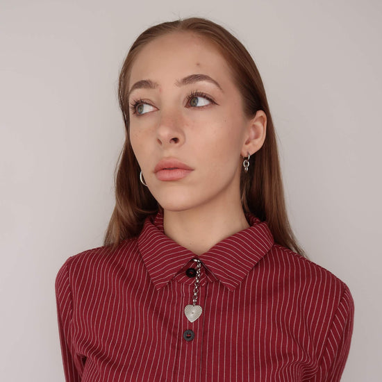 Woman wearing a red striped shirt with a neutral background