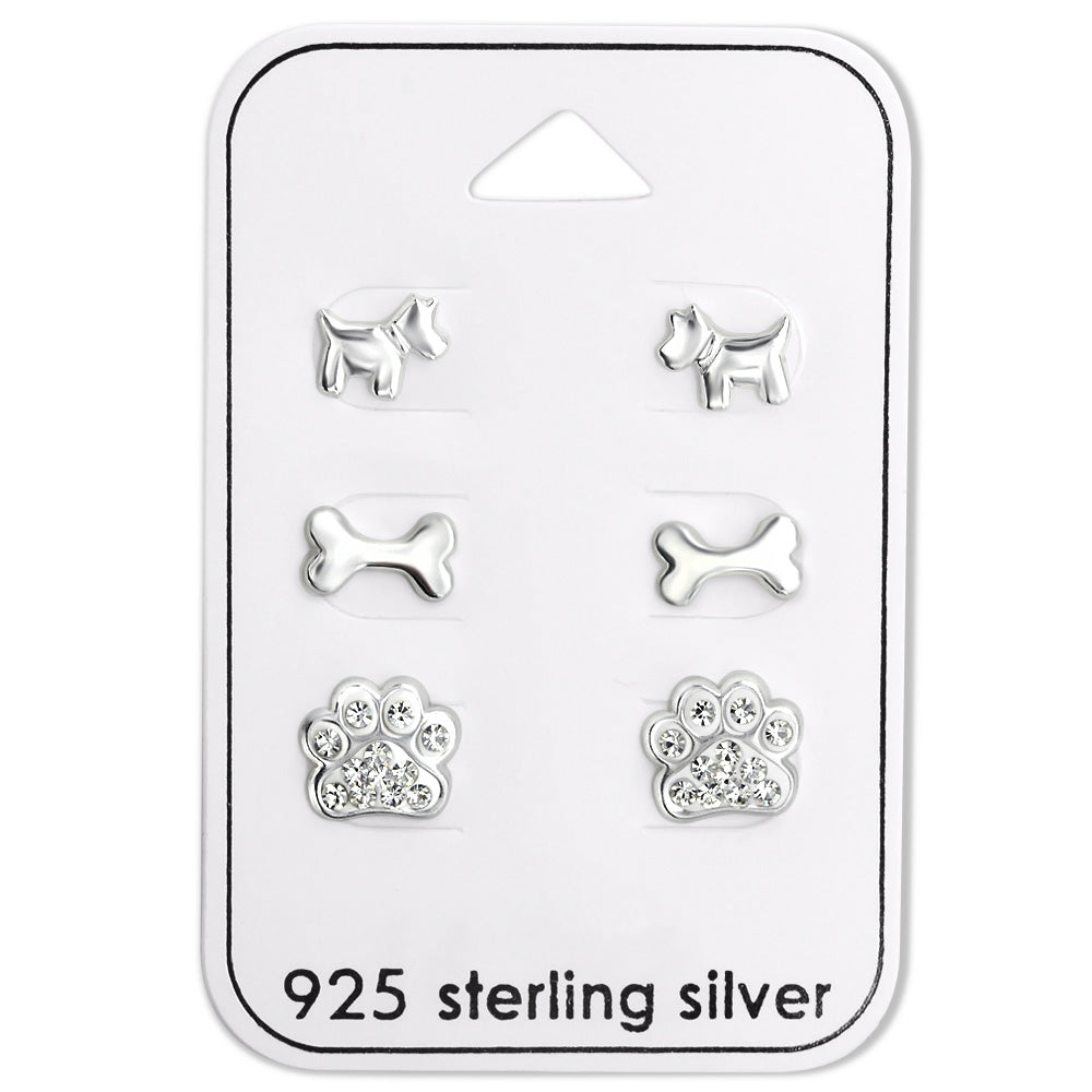 This set includes three different themed sterling silver dog themed kids earrings. The first earring is a dog body stud, then a dog bone silver stud, then one of our popular sparkling diamonte rhinestone paw print earrings. 